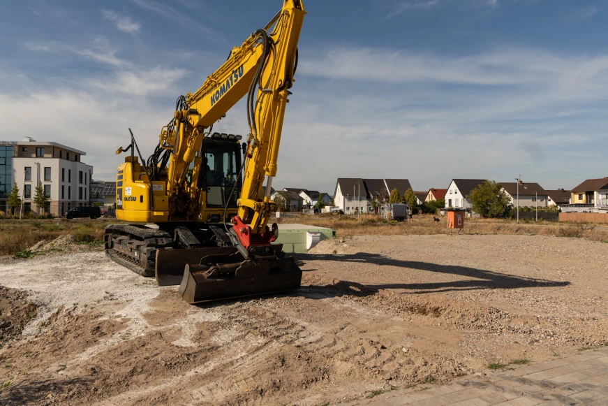 Tracked excavator on the earth beside the basement