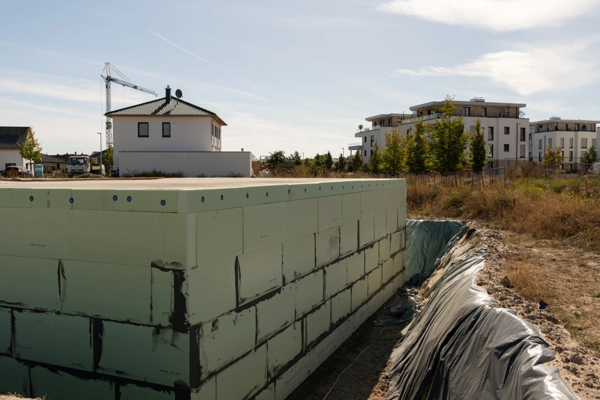 Side wall of the basement, with insulation panels and adjacent working space