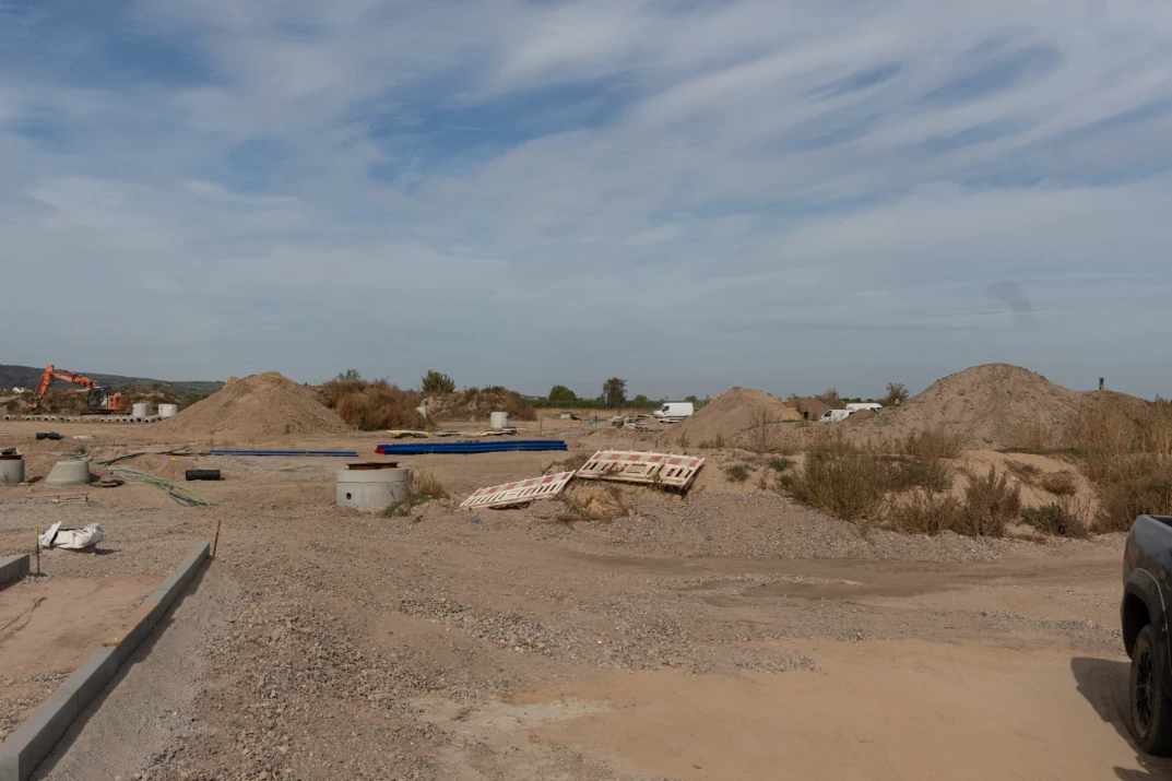 Concrete access chambers, utility pipes and soil heaps in the infrastructure work areas in Wachenheim